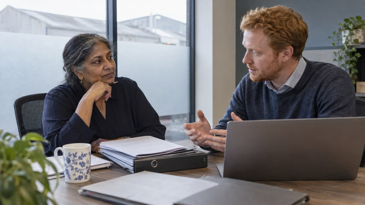 A business founder discussing records with an accountant.