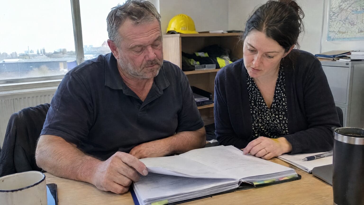 A trade business owner going over contracts with his accountant